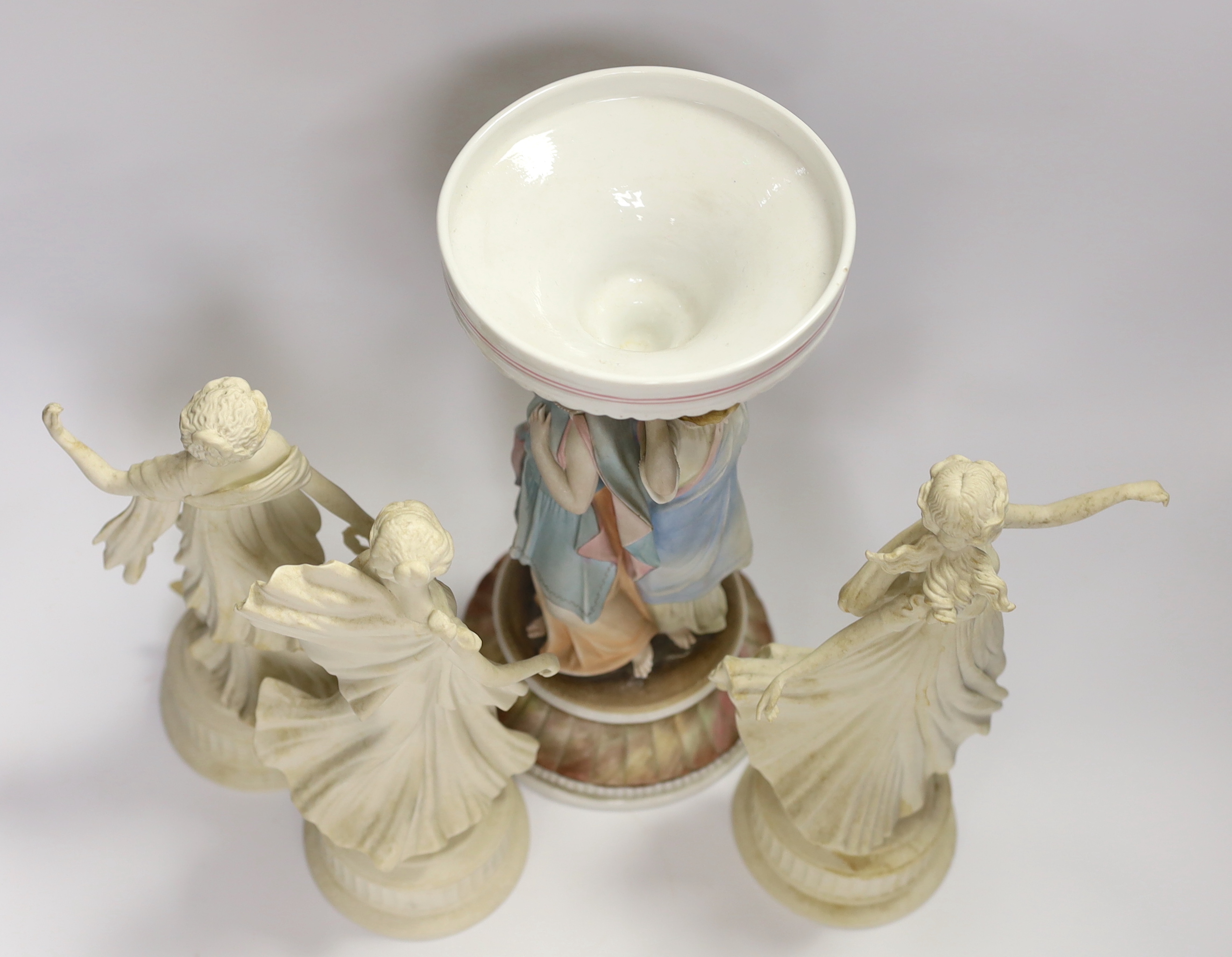 Three Wedgwood Dancing Hours figurines and a 19th century porcelain three graces centrepiece, largest 30cm high